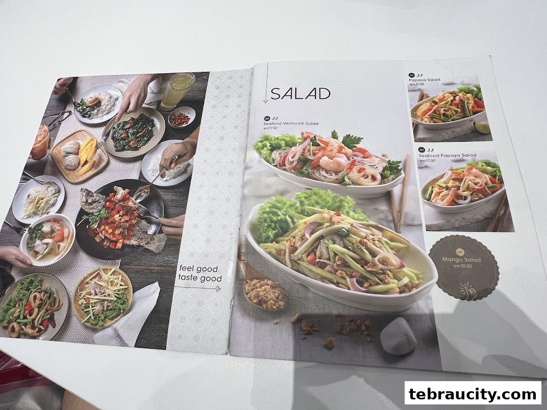 A menu featuring various Thai salads with appetizing food photography.