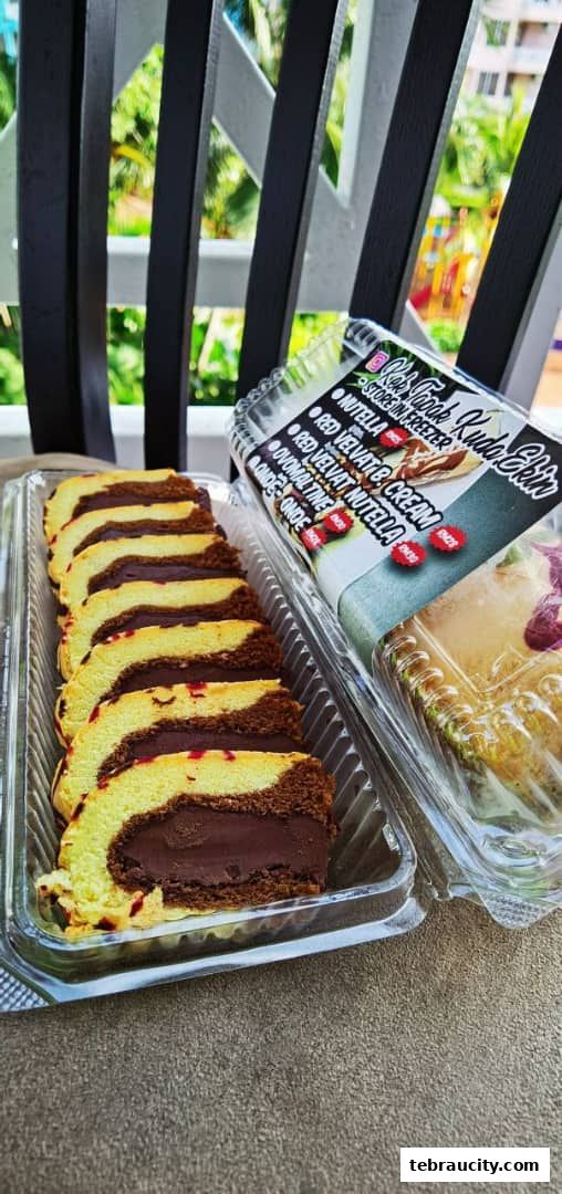 Close-up of sliced chocolate and vanilla swiss rolls with a rich chocolate filling.