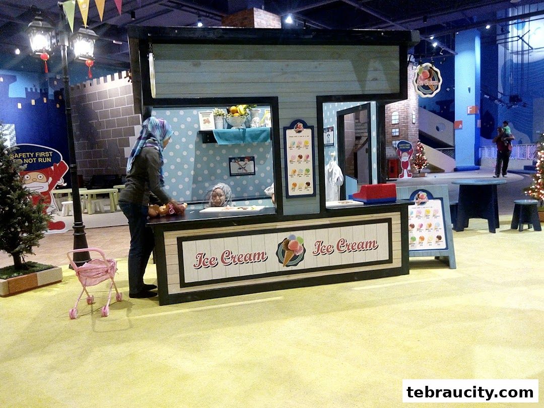 An ice cream stall with a person serving customers in a playful, themed environment.
