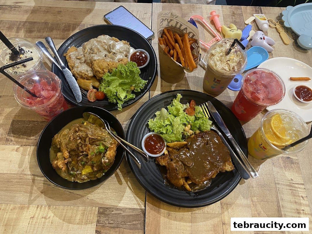 A table laden with various dishes and drinks, including steak, fried chicken, fries, and colorful beverages.