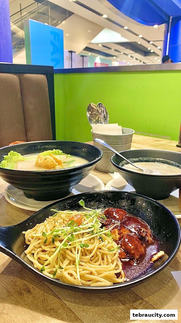 Three bowls of delicious food, including pasta and soup, are arranged on a table.