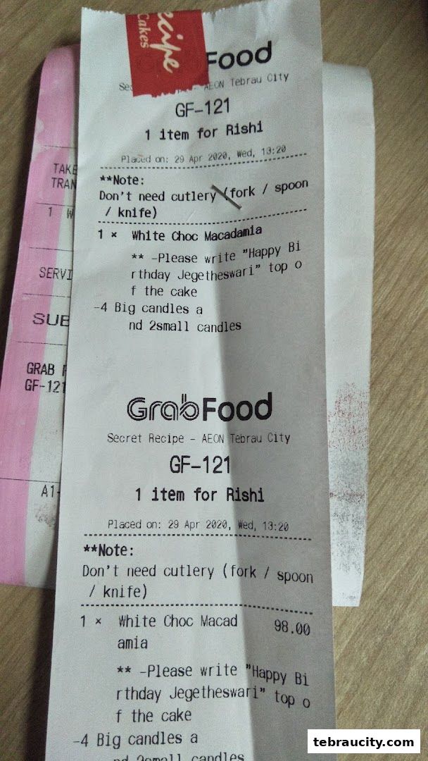A receipt from Secret Recipe for a White Choc Macadamia cake with custom writing and candles.