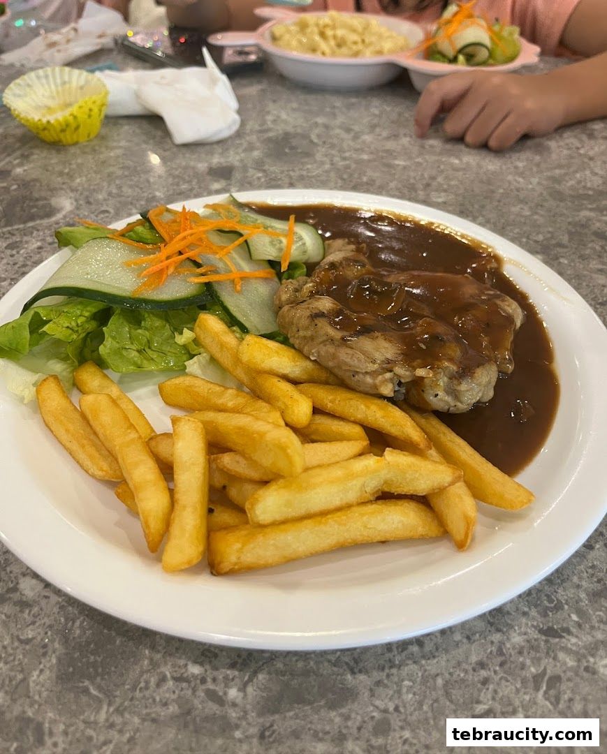 A plate of chicken steak with fries and salad, served at Secret Recipe.