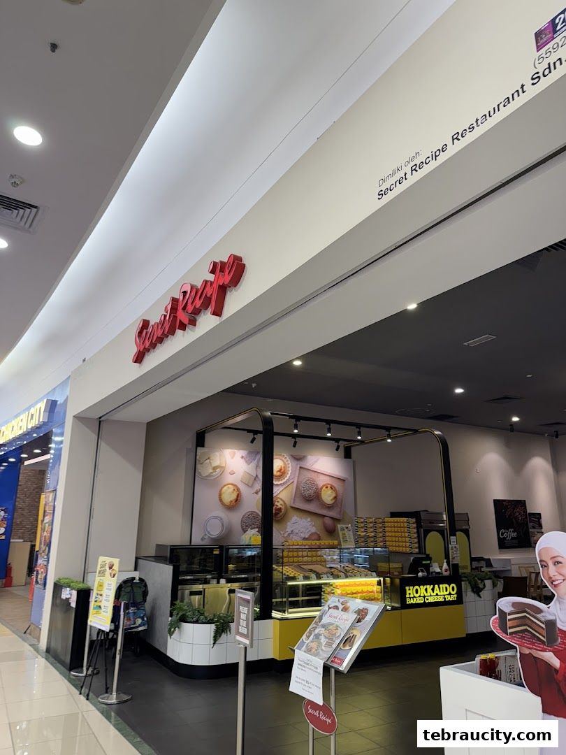 The exterior of a Secret Recipe bakery shop with a display of cakes and tarts.