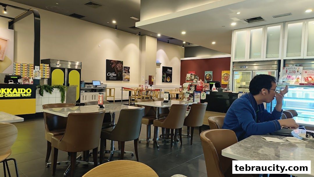 Interior view of a Secret Recipe cafe with tables, chairs, and a display counter.