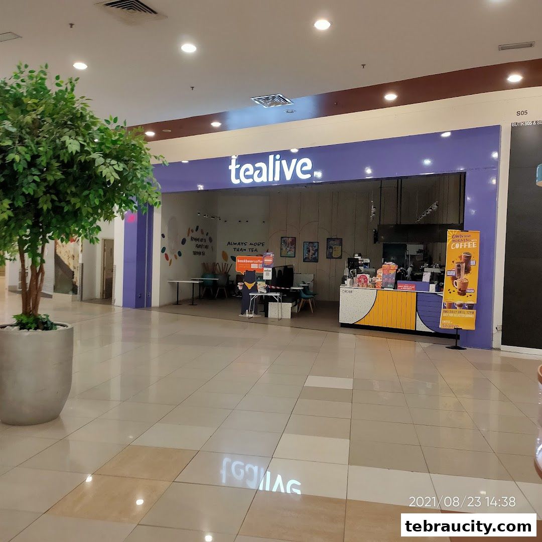 The Tealive shop front with its signature purple and yellow branding, featuring a counter and seating area.
