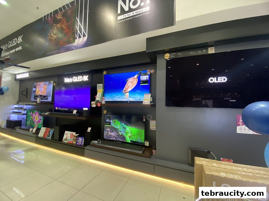A display of various televisions, including Samsung Neo QLED 8K and LG OLED models.