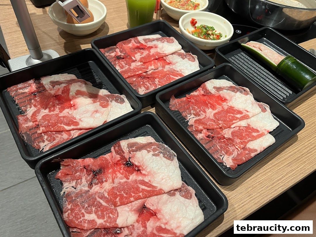 Plates of thinly sliced raw beef and other ingredients for hot pot.