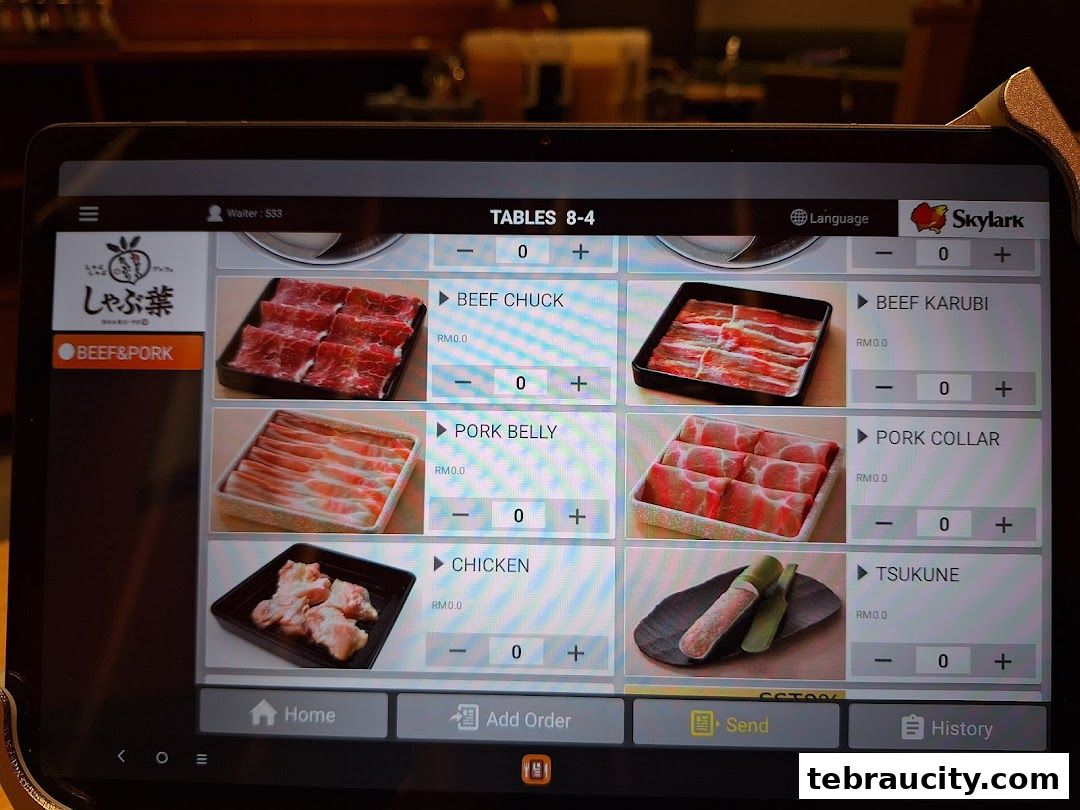 A tablet screen displaying a digital menu for Shabu-Yo with various meat options.
