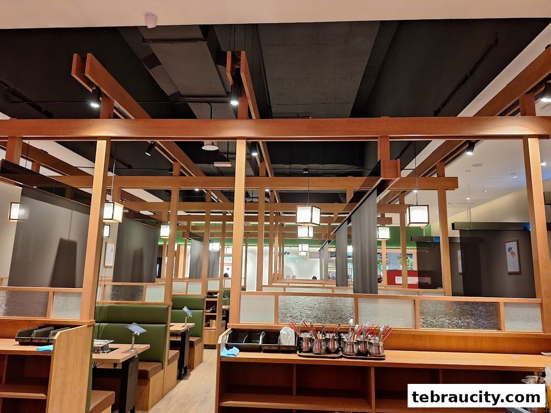 Interior view of a modern shabu-shabu restaurant with wooden partitions and booth seating.