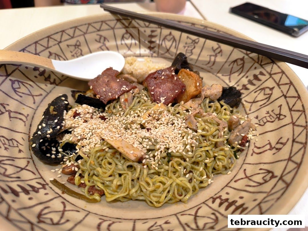 A close-up of a delicious bowl of mala noodles with various toppings and sesame seeds.