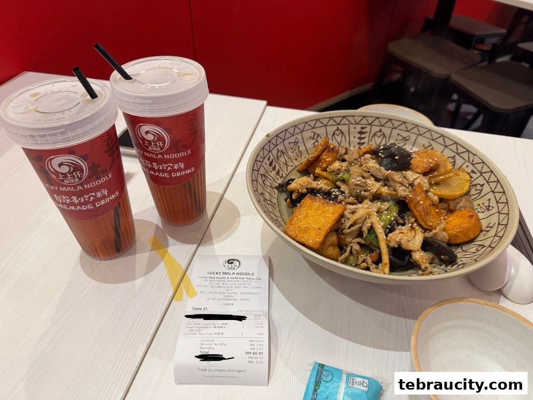 A bowl of mala noodles and two drinks from Lucky Mala Noodle.