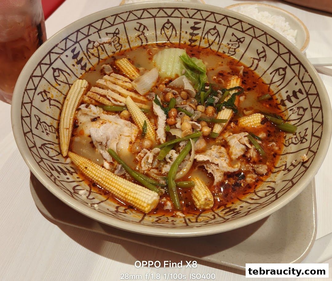 A close-up of a delicious bowl of Mala Tang with baby corn, meat, and vegetables.