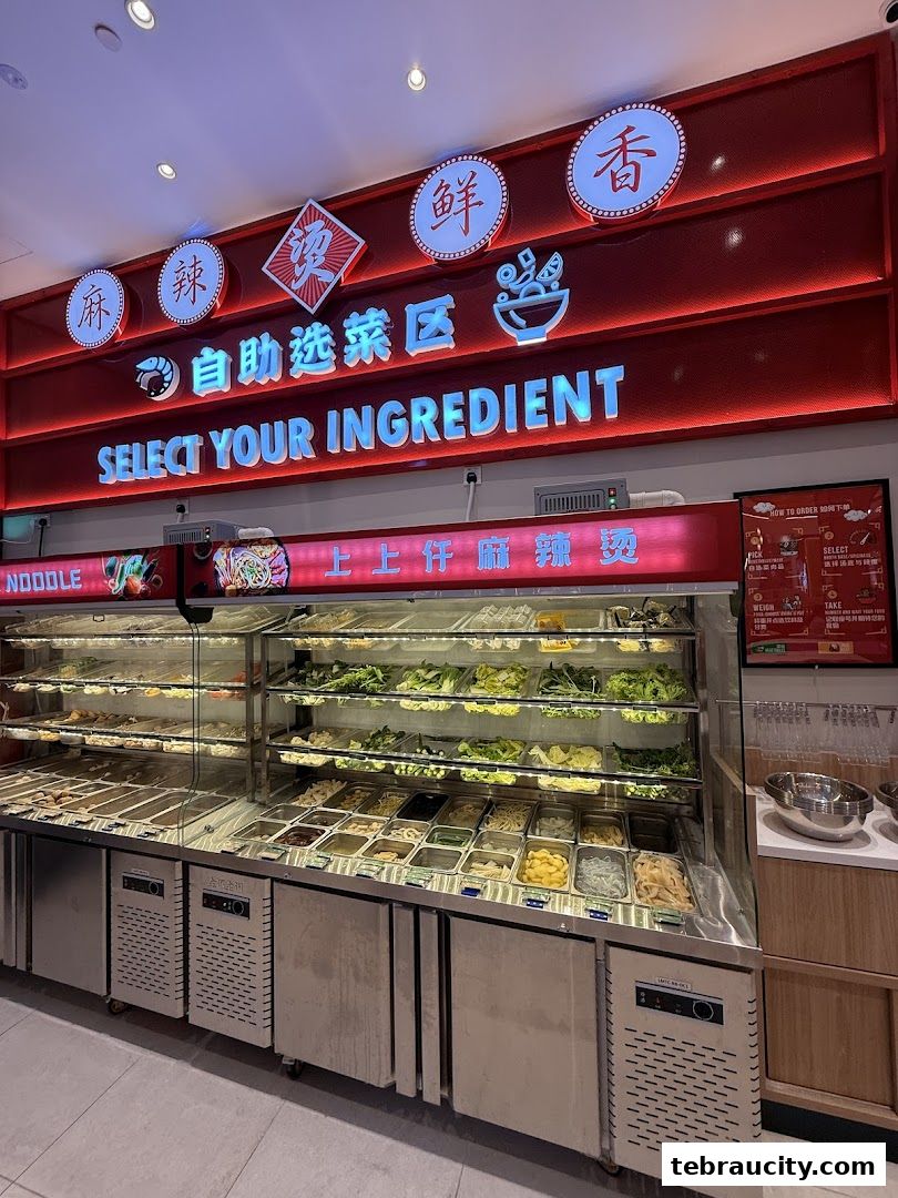 A display of fresh ingredients for Mala Tang, with a sign saying 'Select Your Ingredient'.