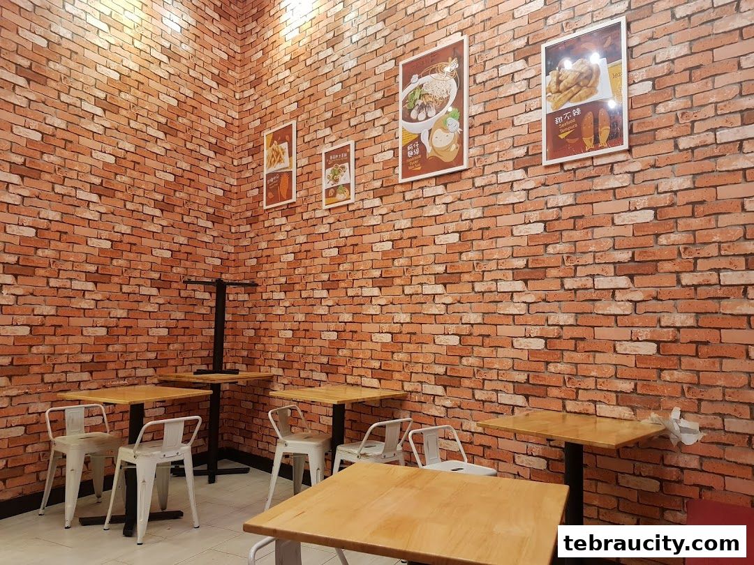 Interior of a restaurant with brick walls, wooden tables, and chairs.
