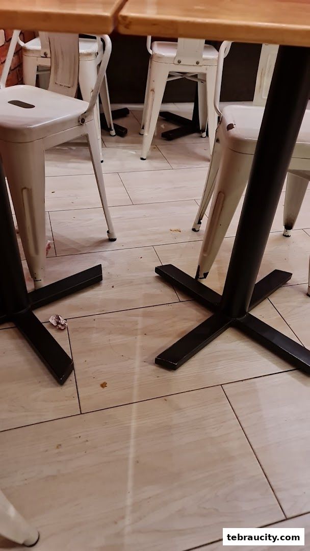 A close-up view of tables and chairs inside a restaurant.