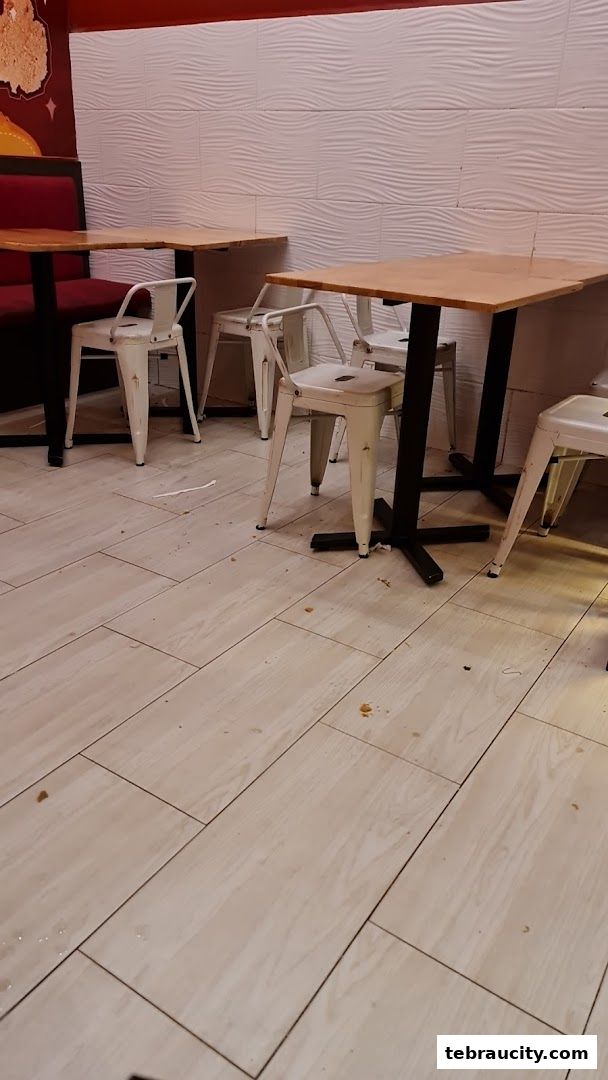 Interior shot of Shihlin Taiwan Street Snacks with tables and chairs.
