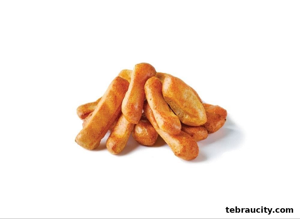 A pile of golden-brown, crispy fried snacks dusted with seasoning.