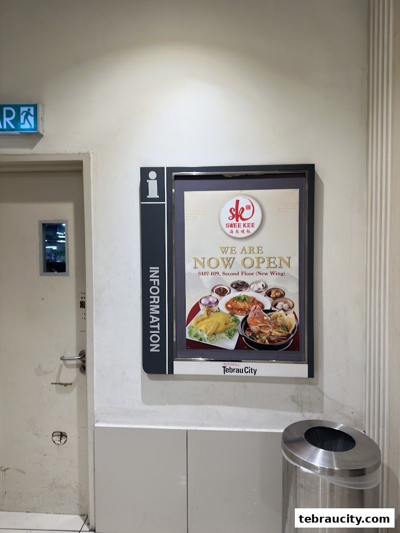 A sign announcing the 'Now Open' status of Swee Kee Hainanese Chicken Rice.