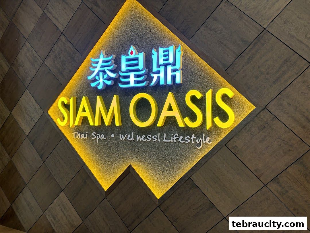 A brightly lit sign for Siam Oasis Thai Spa and Wellness Lifestyle.