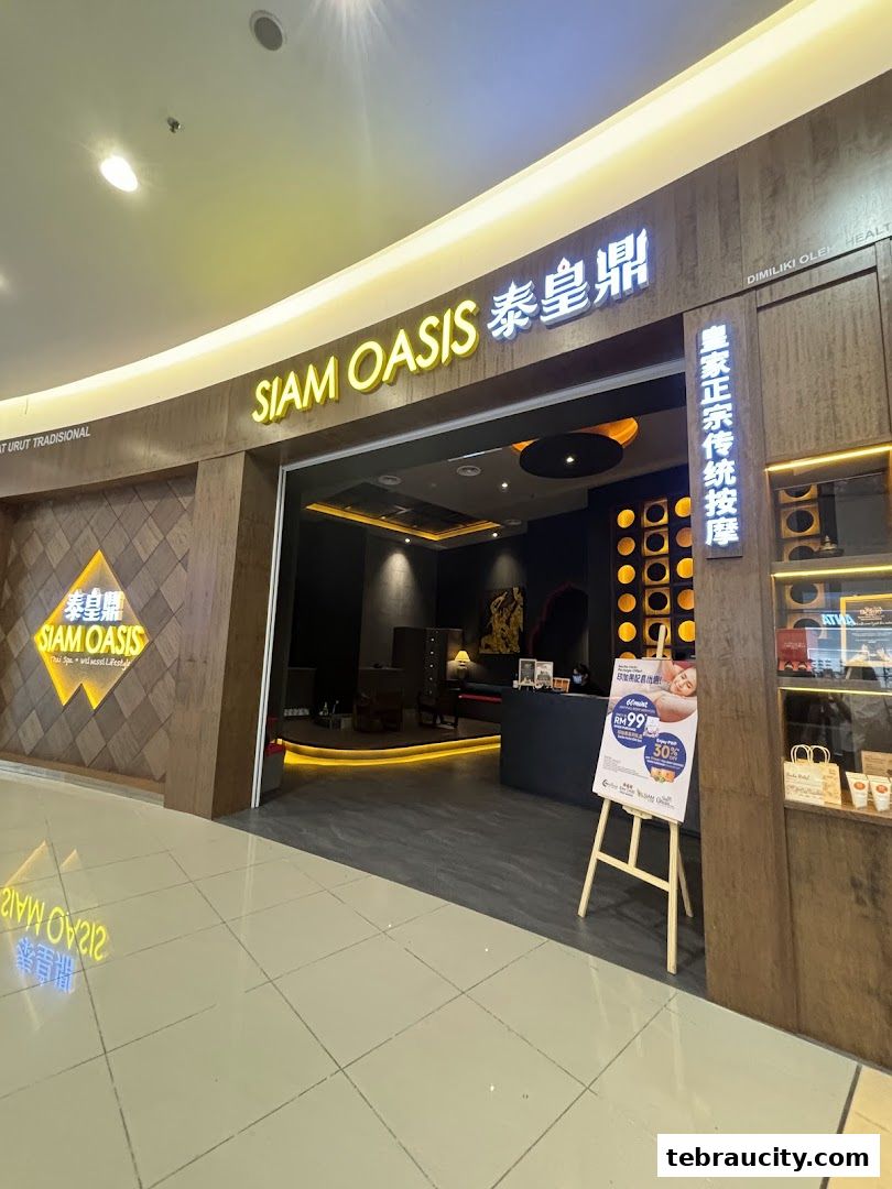 The entrance of Siam Oasis, a Thai spa, with a promotional sign outside.