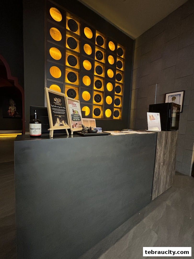A reception counter with decorative lighting and promotional signs.