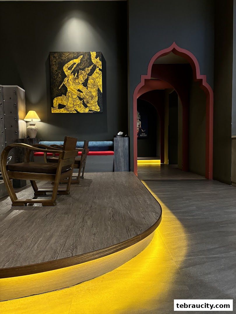 Interior of a spa with seating area, artwork, and arched doorways.