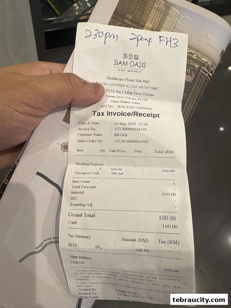 A hand holds a receipt from Siam Oasis, a healthcare and wellness establishment.