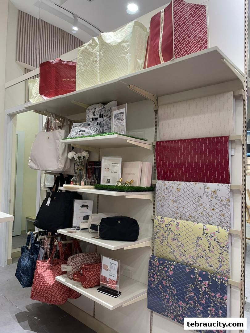 A display of branded bags and patterned fabrics on shelves in a retail store.