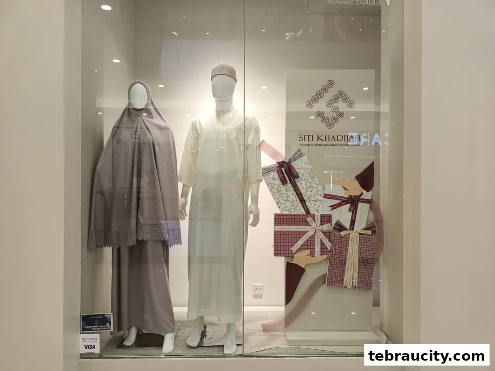 Shop window display featuring mannequins in traditional attire and gift boxes.