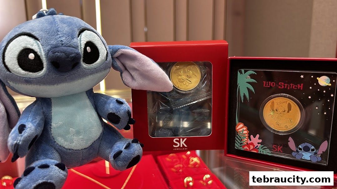 A Stitch plush toy sits next to Lilo & Stitch themed gold coins from SK Jewellery.