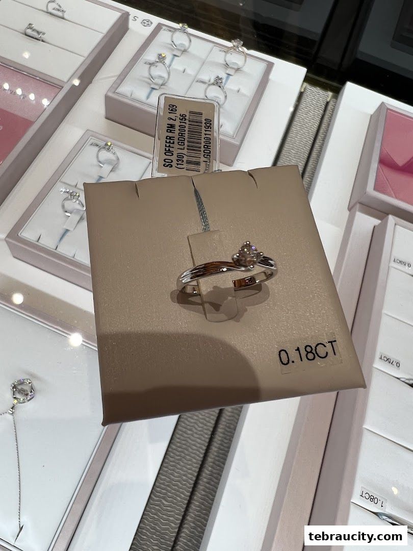 A close-up of a diamond ring displayed on a beige stand with a price tag.