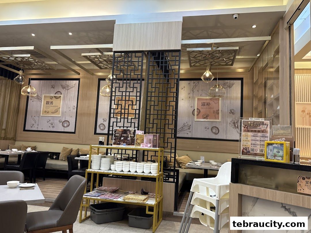 Interior view of a restaurant with tables, chairs, and decorative elements.