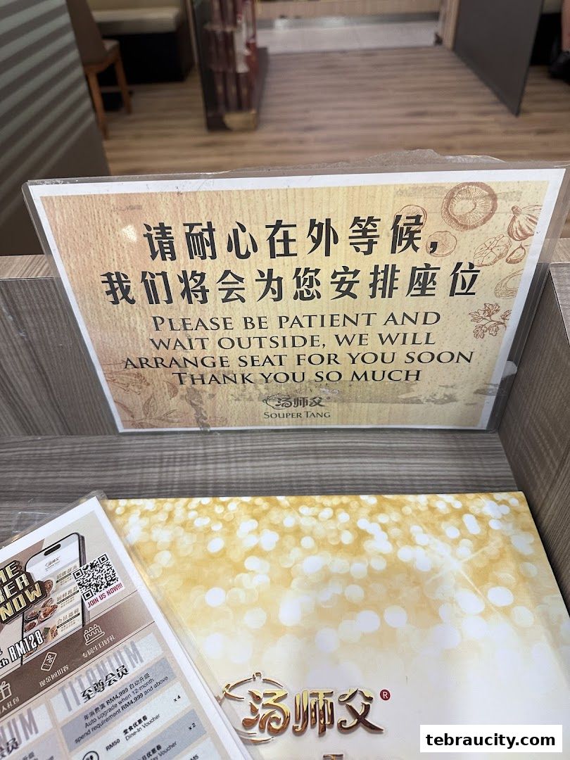 A sign at Souper Tang restaurant asking customers to wait patiently outside for seating.
