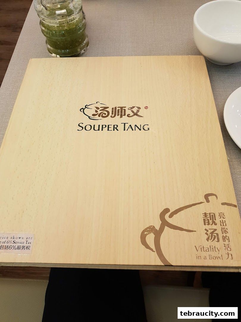 A wooden menu from Souper Tang restaurant with Chinese and English text.