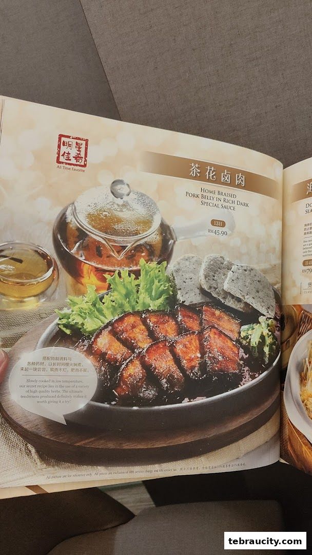 A menu page featuring a dish of home-braised pork belly in rich dark special sauce.