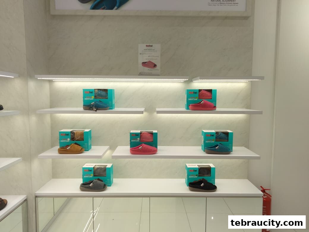 A display of MediFeet joint care slippers in various colors on shelves.
