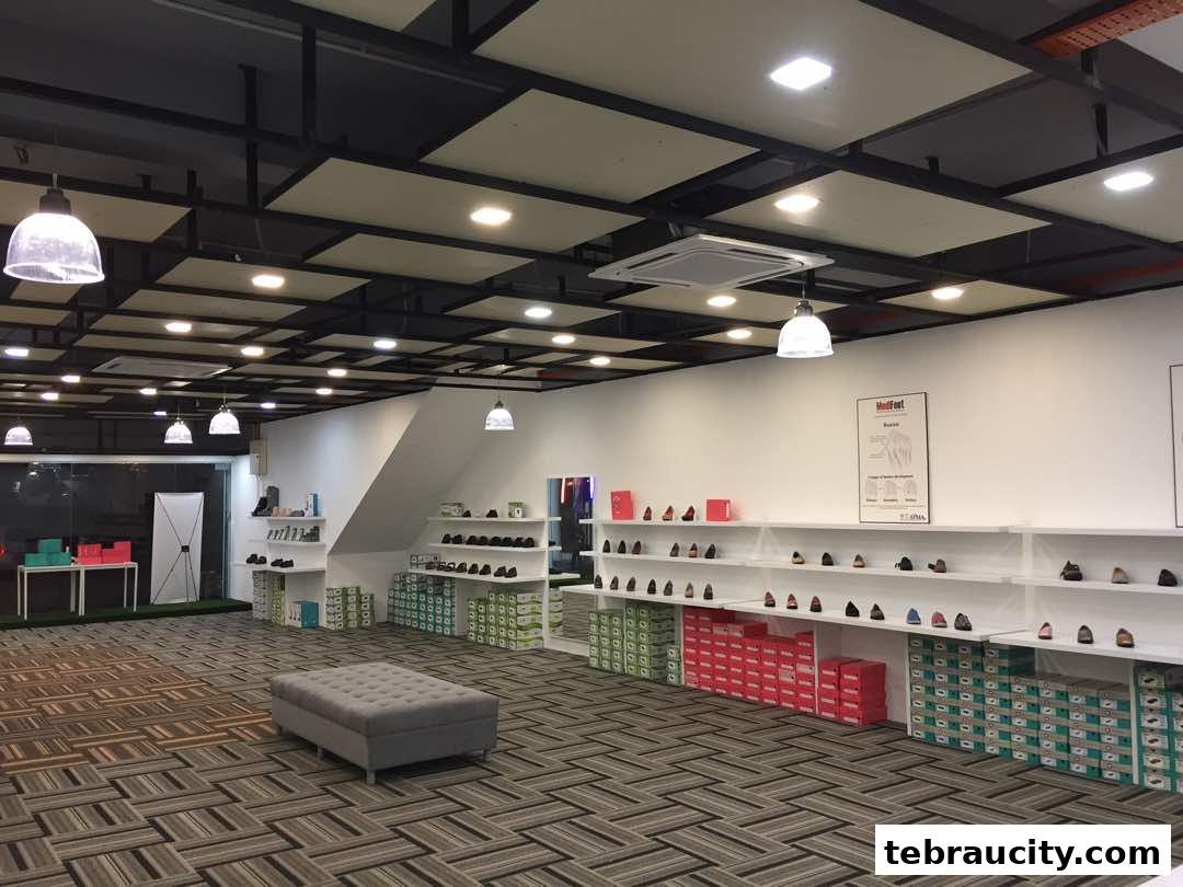 Interior view of a modern shoe store with shelves displaying footwear and boxes.
