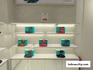 A well-lit display of comfortable footwear, showcasing various colors and styles on shelves.