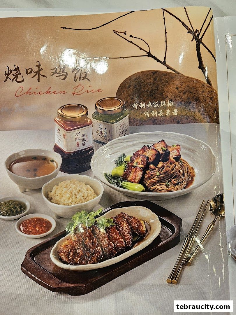 A visually appealing display of chicken rice dishes with various condiments and accompaniments.