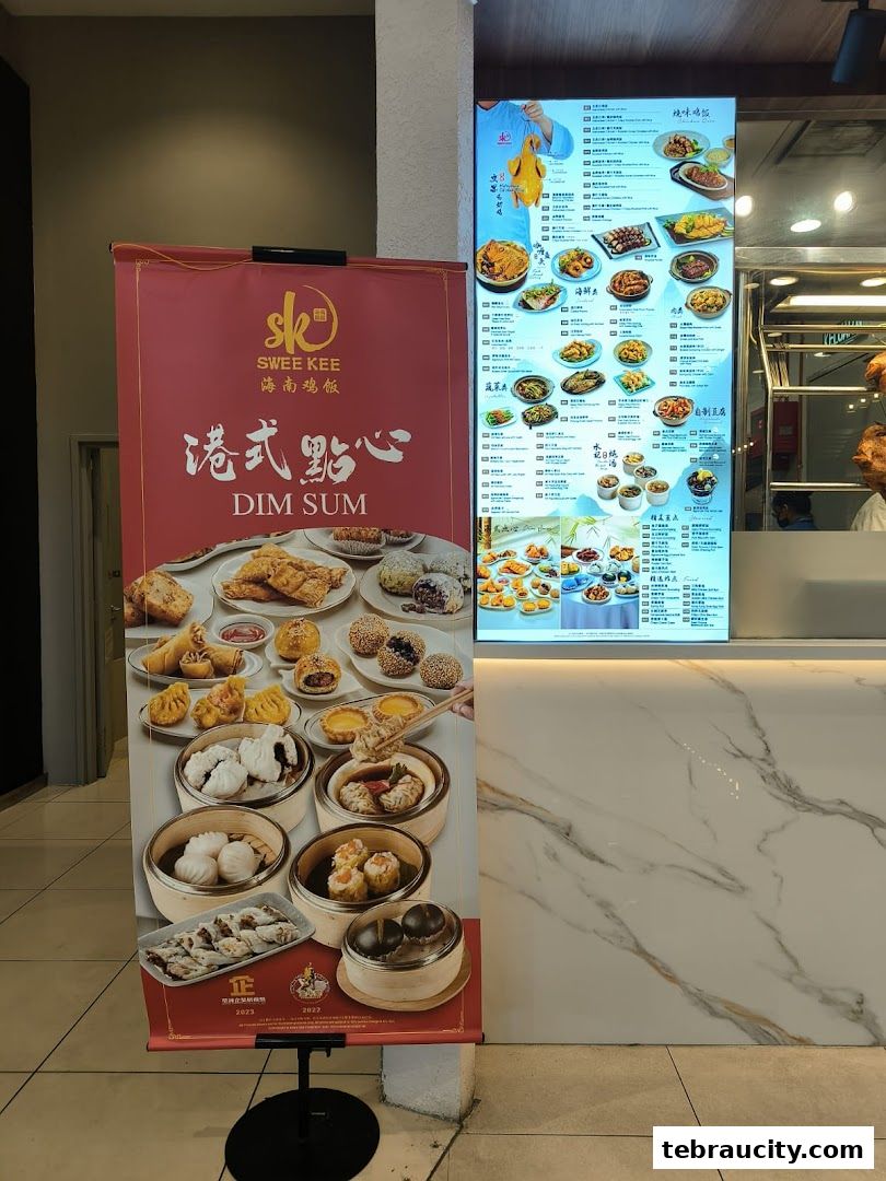 A red banner advertising Dim Sum and a digital menu board displaying various dishes.