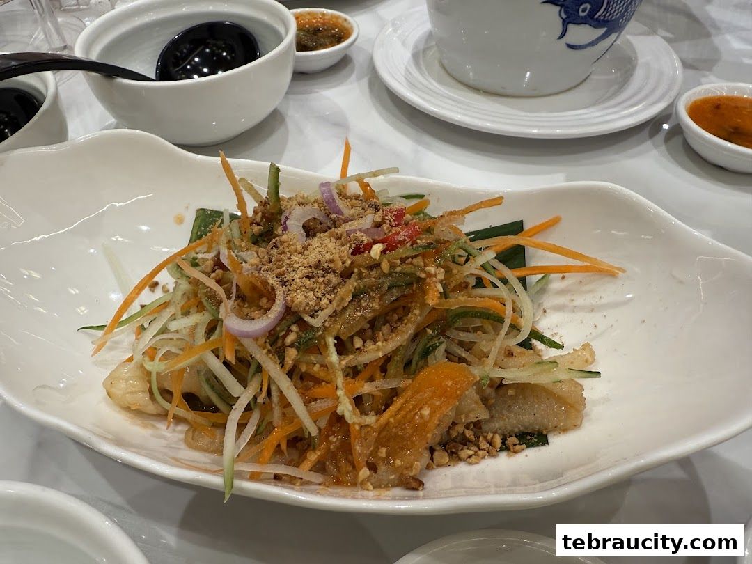A close-up of a delicious salad with shredded vegetables and crushed peanuts.