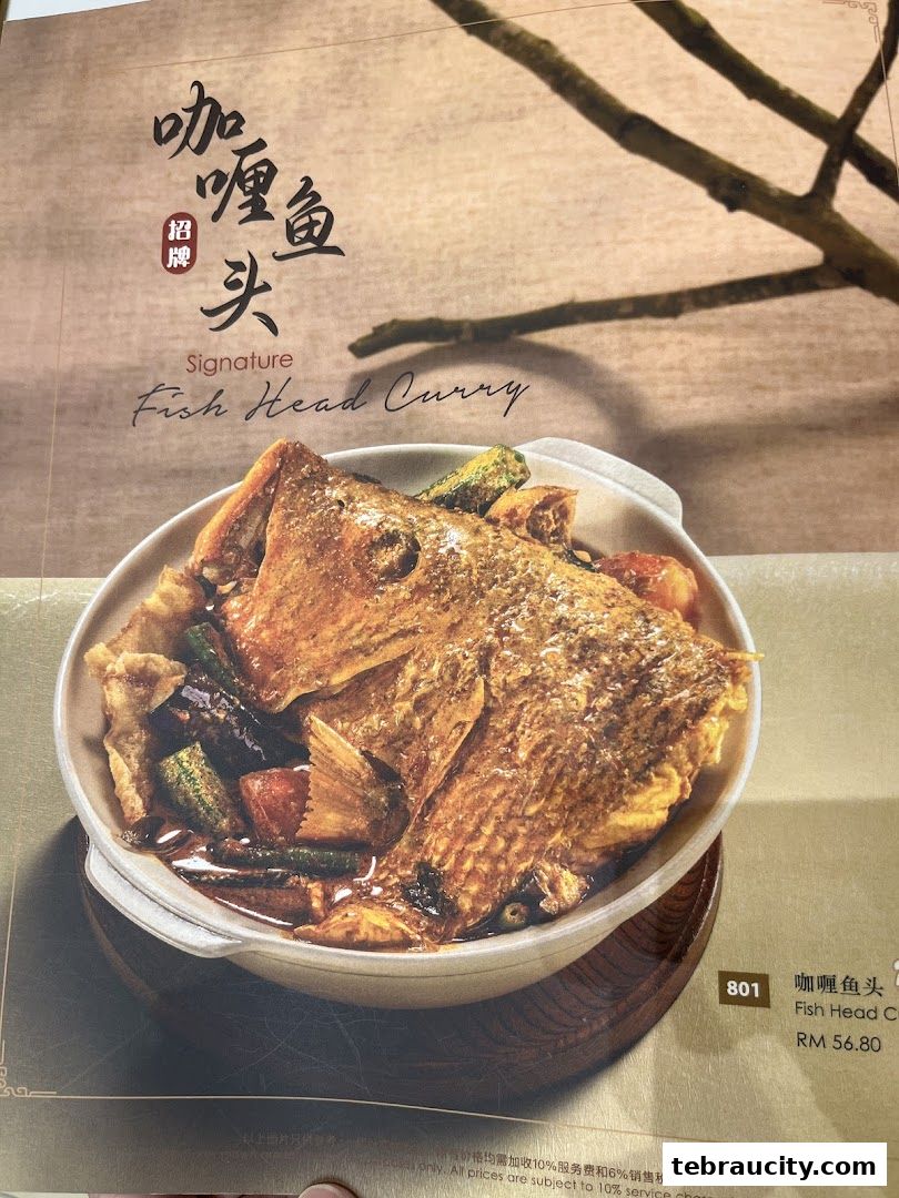 A close-up of a menu item featuring a signature fish head curry dish.