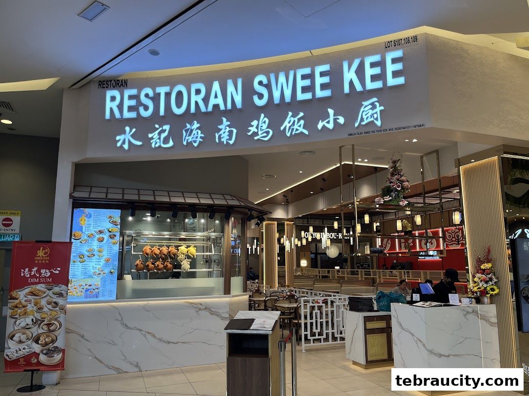 The exterior of Swee Kee Chicken Rice restaurant with a prominent sign and display of roasted chickens.