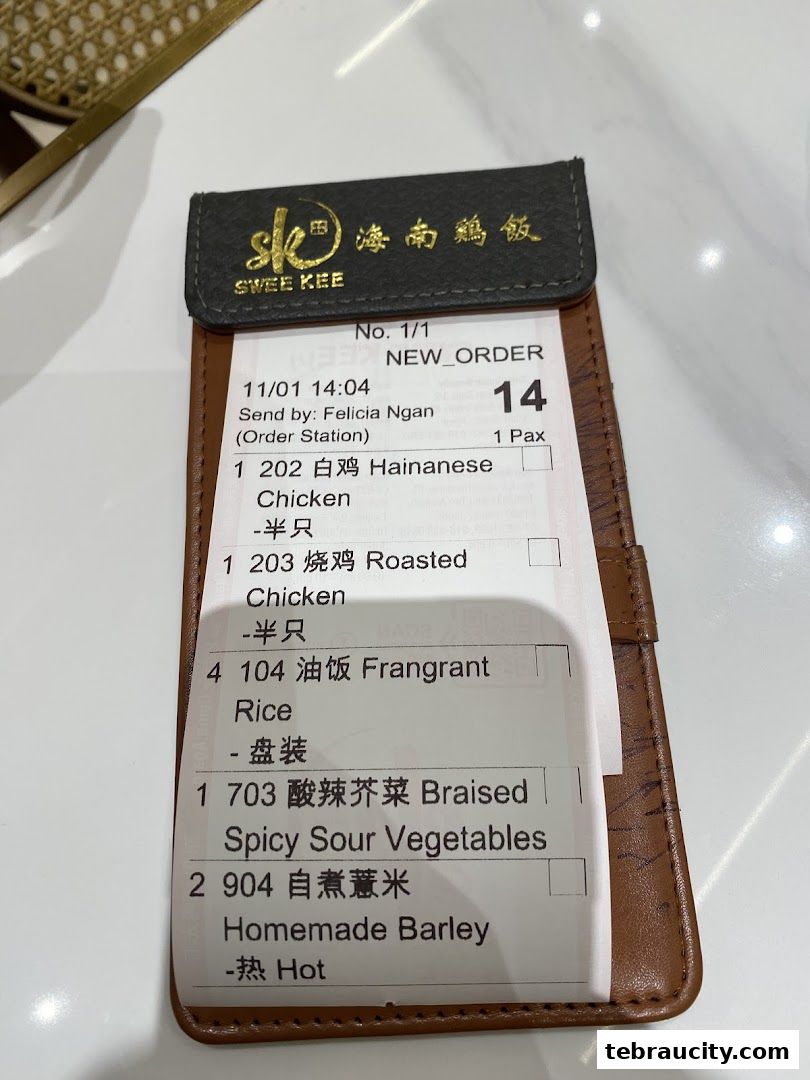 A receipt from Swee Kee Chicken Rice showing a food order with various chicken and rice dishes.