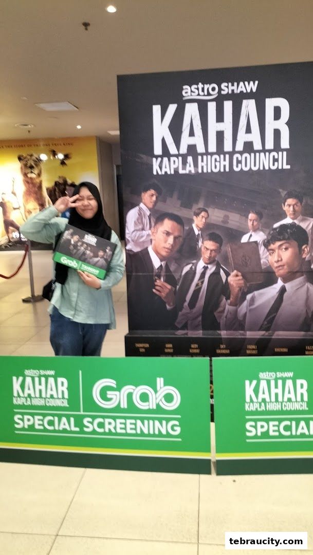 A person poses with promotional material for the movie 'Kahar Kapla High Council'.
