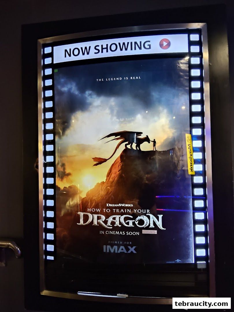 A movie poster for 'How to Train Your Dragon' is displayed on a lit-up sign.
