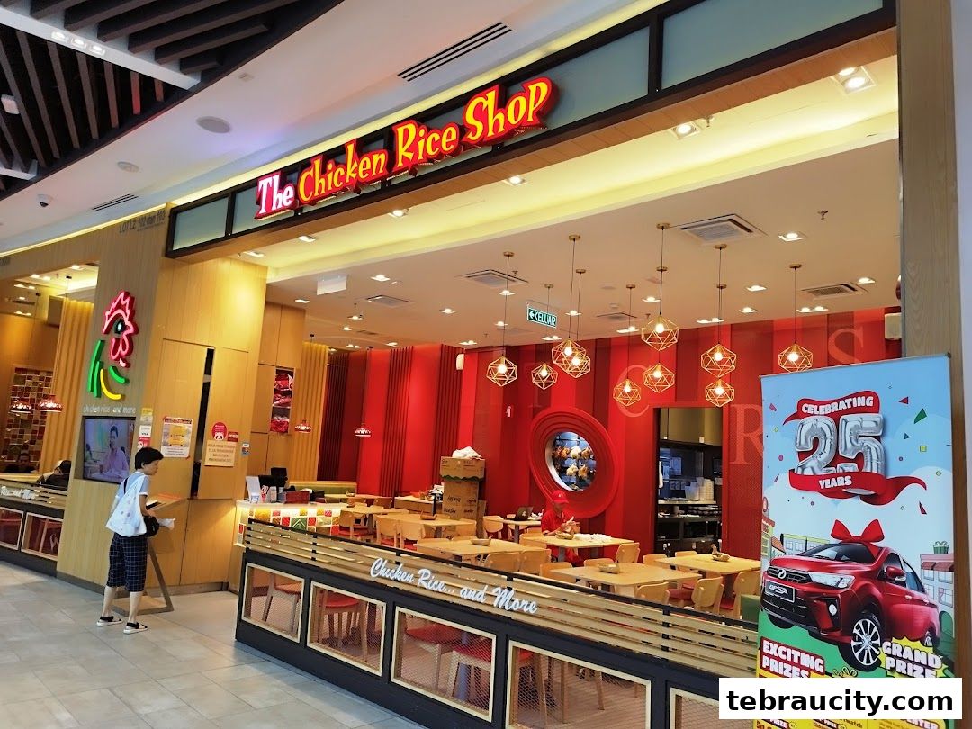 The Chicken Rice Shop storefront with interior seating and a promotional banner.