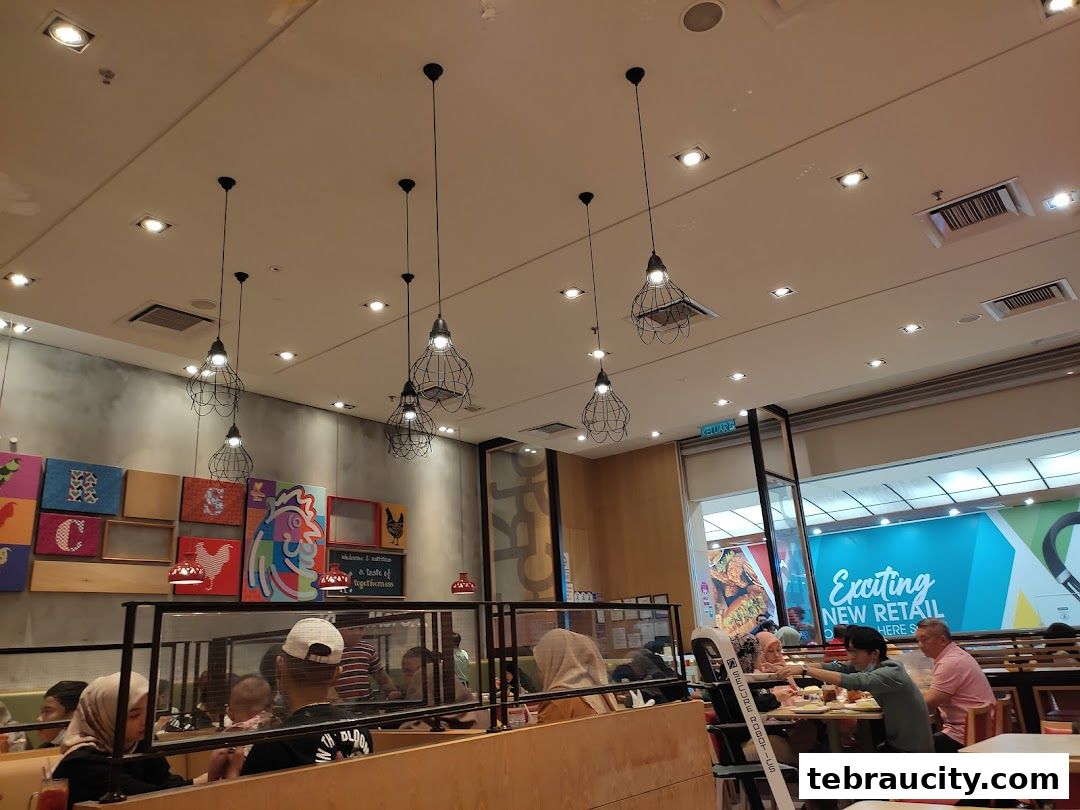 Interior view of The Chicken Rice Shop with diners and decorative wall art.
