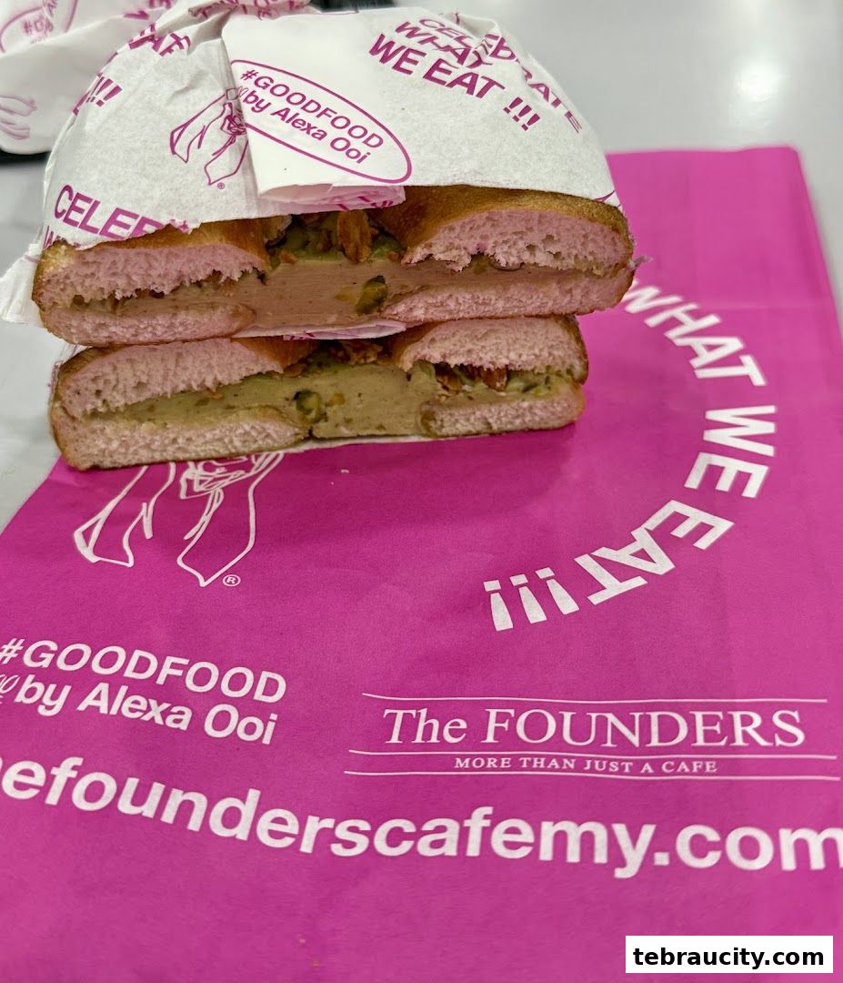 A delicious-looking bagel sandwich from The Founders Bakery, presented on branded packaging.